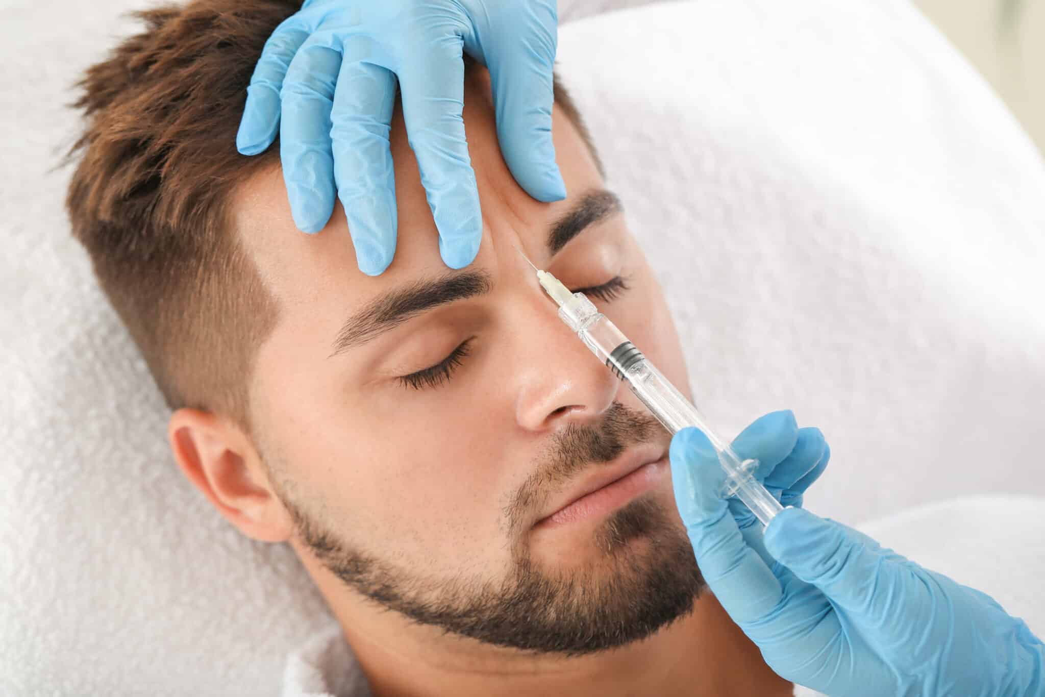 Receiving forehead Botox treatment in med spa